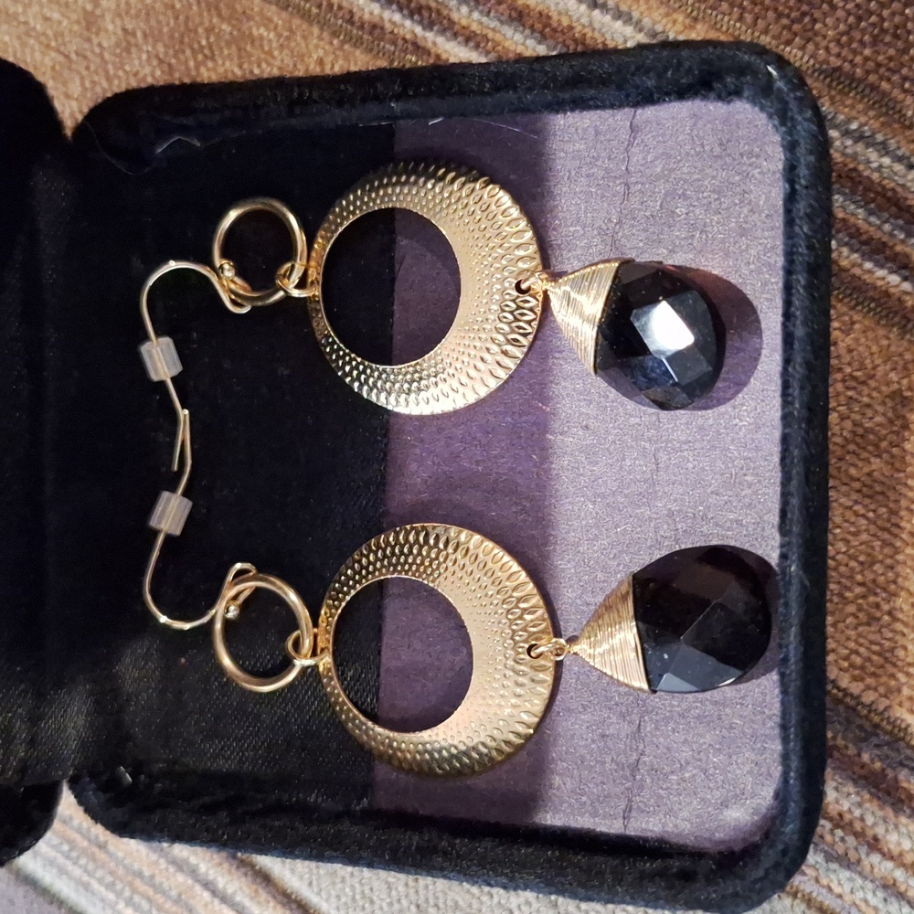 Gold tone and dark crystal dangle earrings